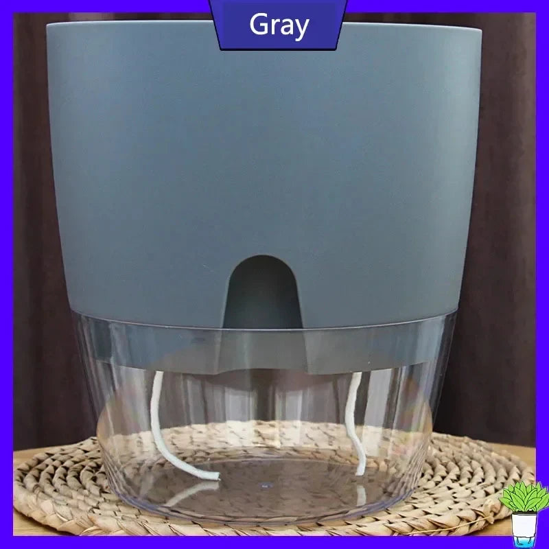 Gray planter on a woven mat, with the clear reservoir visible at the base