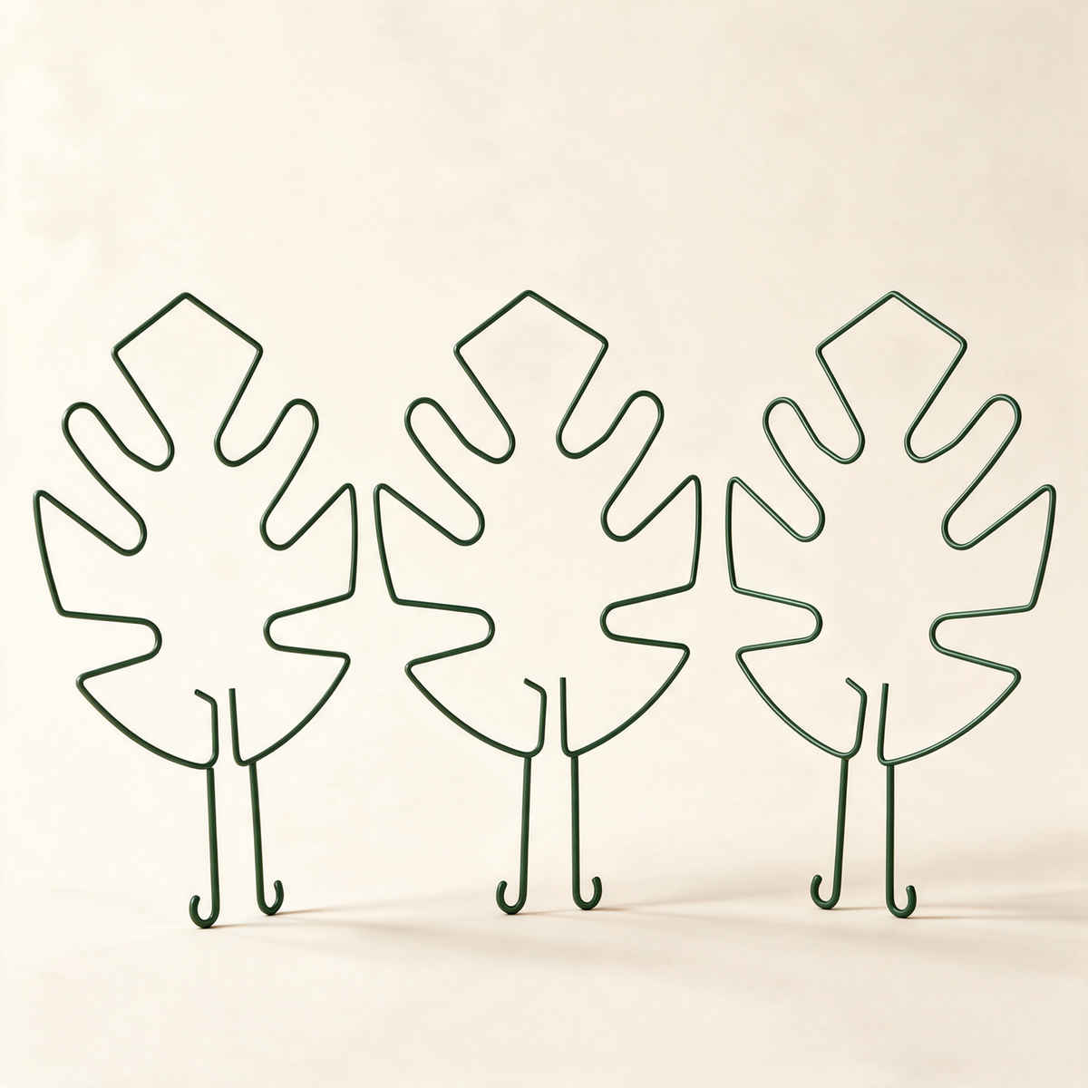 Set of three green leaf-shaped plant stem support hoops.