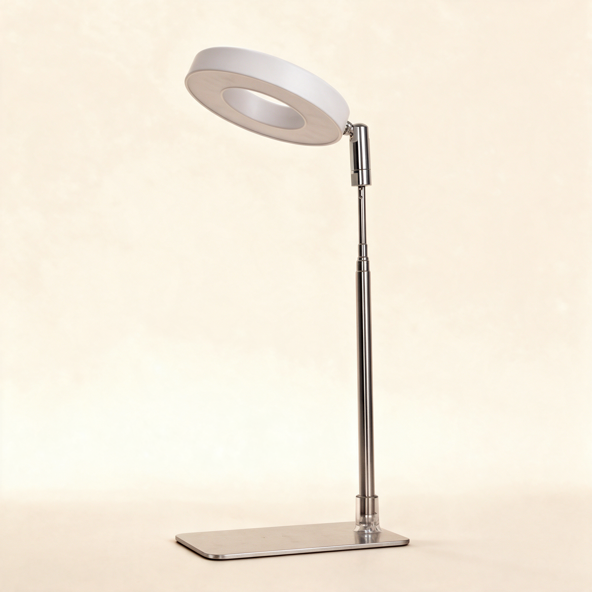 White ring grow light on a chrome telescoping stand.