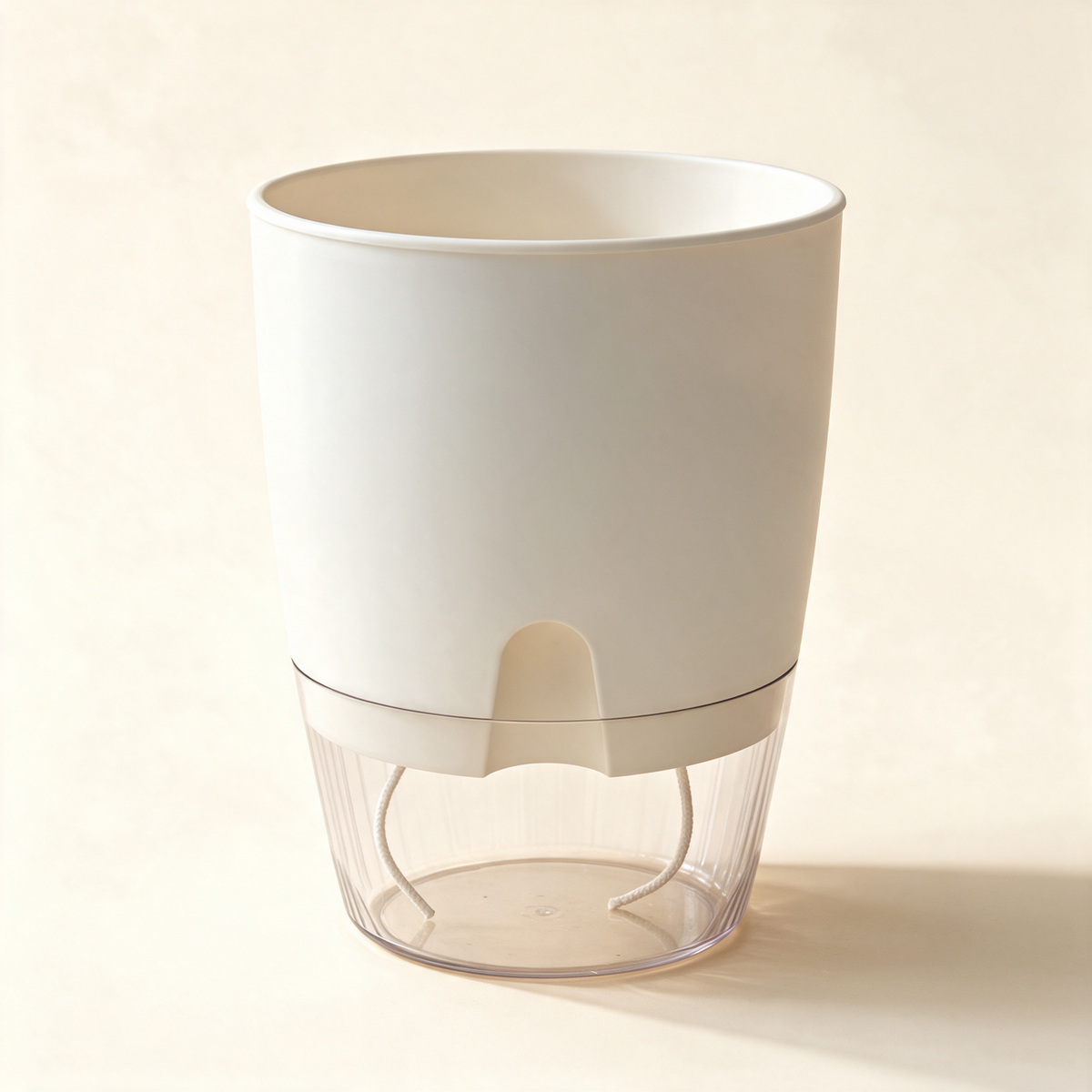 White self-watering planter with a clear ribbed reservoir and two cotton wicks.